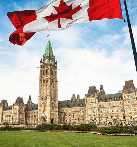 Government Building on Parliament Hill in Ottawa with canada flag